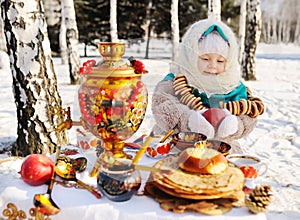 Baby girl in coat and headscarf in the Russian samovar in the ba