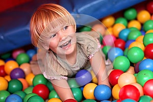 Baby girl and colourful balls