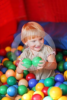 Baby girl and colourful balls