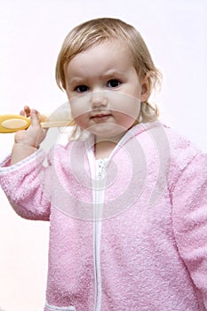 Baby girl combing hair