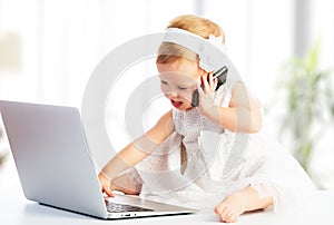 Baby girl with computer laptop, mobile phone