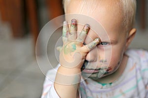 Baby Girl COvering Messy Face with Little Hands