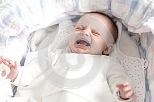 Baby girl crying in her crib
