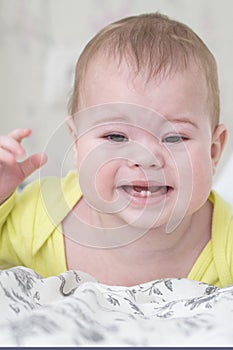 Baby girl crying teething. Baby upset because of toothache. Portrait of baby child close-up soft focus