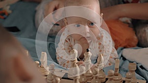 Baby girl is curious about chess