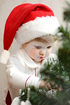 Baby girl decorate the Christmas tree