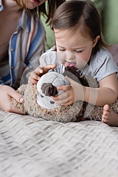 Baby girl with down syndrome holding