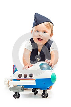 Baby girl dressed as stewardess with airplane toy