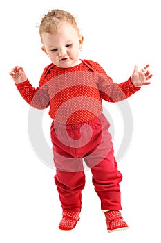 Baby girl dressed in red learning to walk isolated