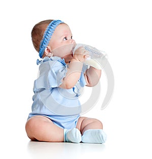 Baby girl drinking milk from bottlee without help