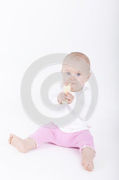 Baby girl eating banana