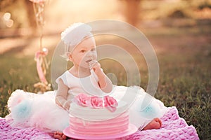 Baby girl eating birthday cake