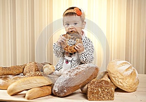 Baby girl eating bread