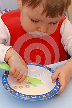 Baby girl eating cereals