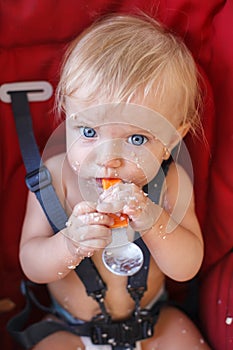 Baby girl eating on her own with spoon