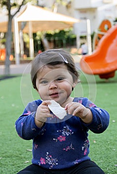 Baby Girl eating a snack