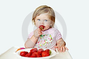 Baby  girl   eating strawberry