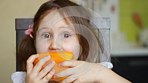 Baby girl eats yellow pepper. Child eating healthy food