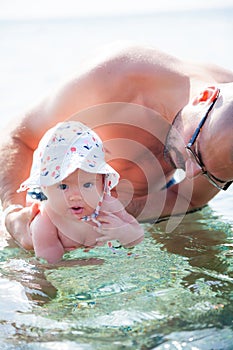 Baby girl enjoying swimming in the sea