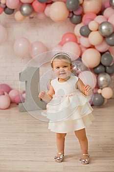 Baby girl  at first birthday with smash cake