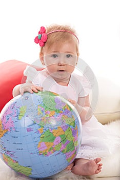 Baby girl with globe