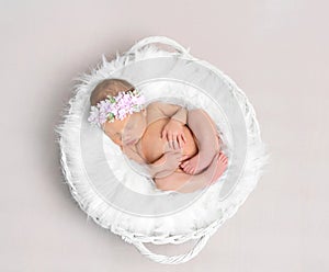 Baby girl with a hairband sleeping, topshot