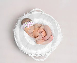 Baby girl with a hairband sleeping, topshot photo