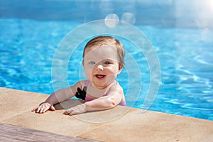 Baby girl is having fun in the pool