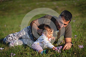 Baby Girl and her Father Sitting in the Field