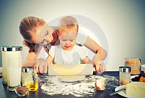 Baby girl with her mother cook, bake photo