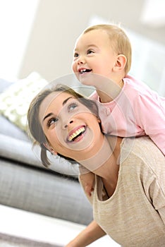 Baby girl with her mother laughing