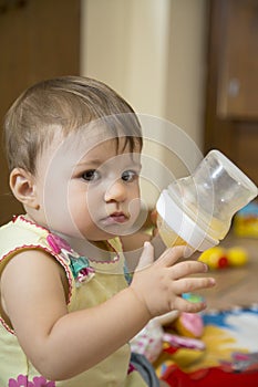 Baby girl holding bottle