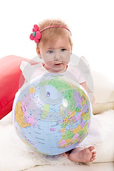 Baby girl holding world ball