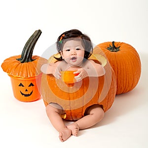 Baby girl inside the pumpkin
