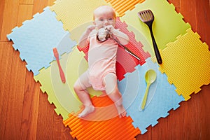 Baby girl with kitchen utensils