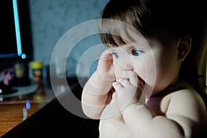 Baby girl in lamp light at evening