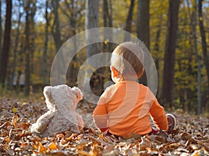 Baby girl laughing and playing in autumn