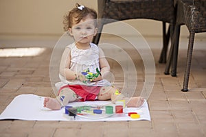 Baby girl learning to paint