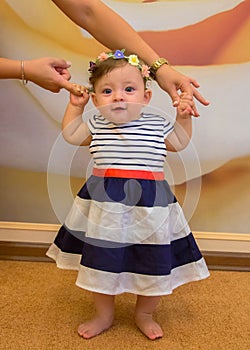 Baby girl learning to walk. First steps