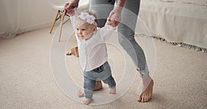 Baby girl learning to walk at home