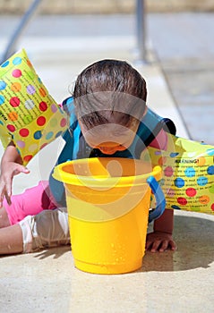 Baby Girl looking into bucket