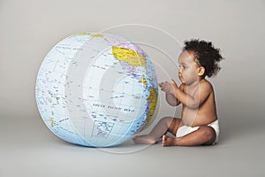 Baby Girl Looking At Inflatable Globe