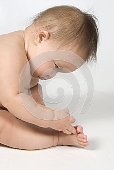 Baby Girl Looking at and touching her toes