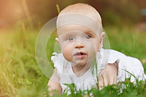 Baby girl lying on grass