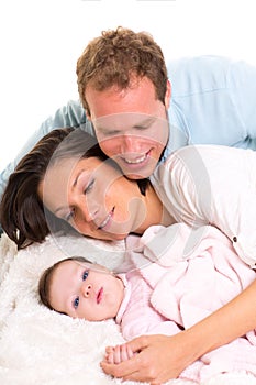 Baby girl mother and father family happy lying together