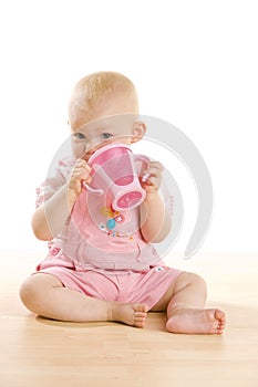 Baby girl with a mug