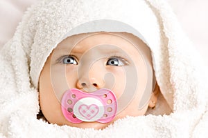 Baby girl with pacifier photo