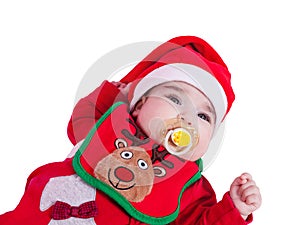 Baby girl with pacifier or dummy, red babygrow or onesie, Rudolph reindeer bib, Santa Claus hat