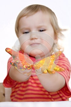 Baby girl with paint on hands