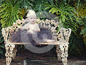 Baby girl on park bench